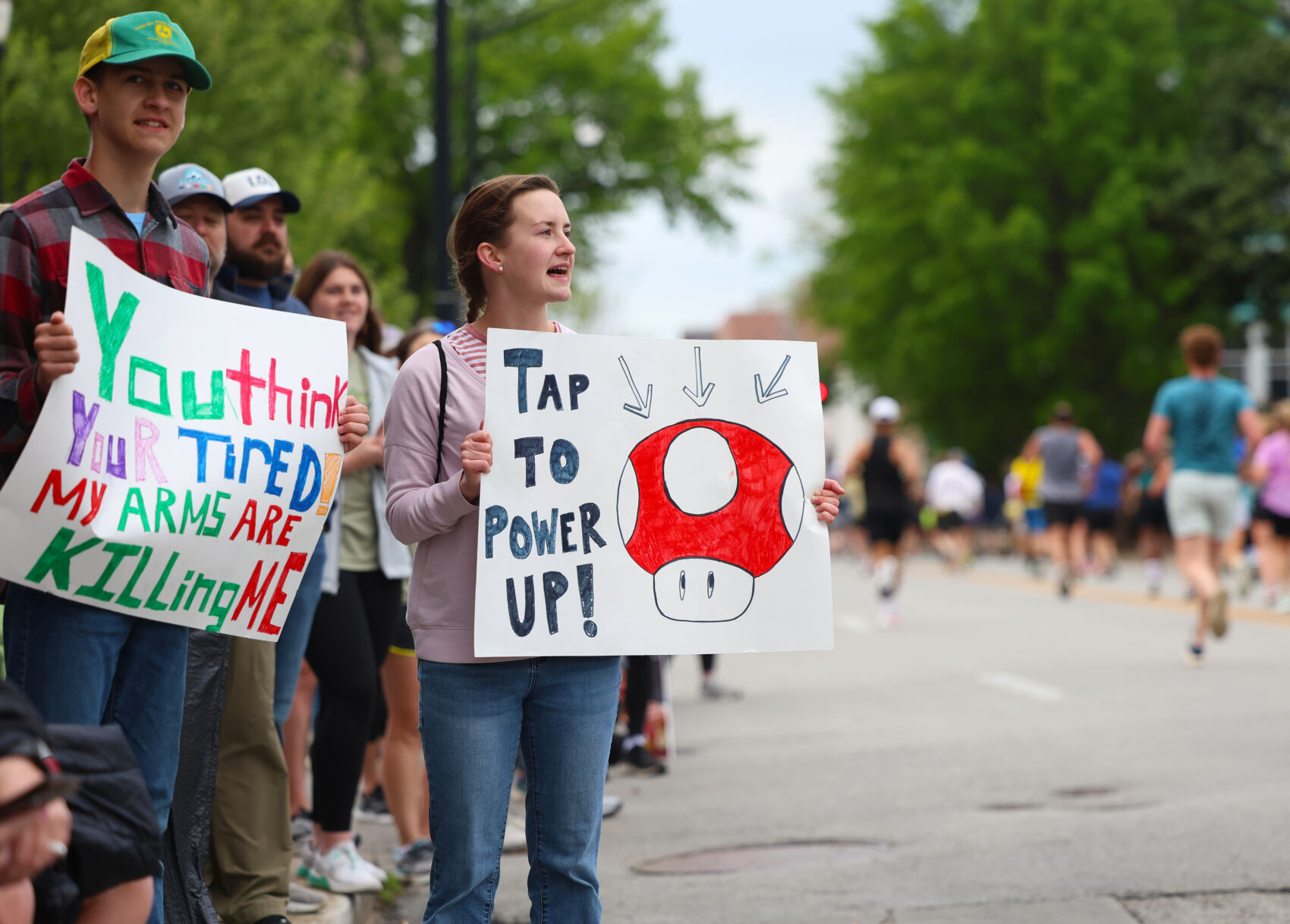 A sign is held in support of runners.JPG